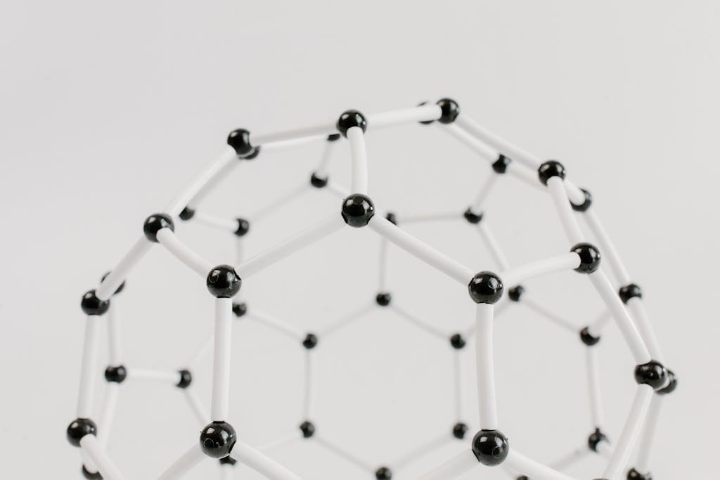 Target Course 1 Close-up of a geometric molecular structure model with black and white connections on a light background.